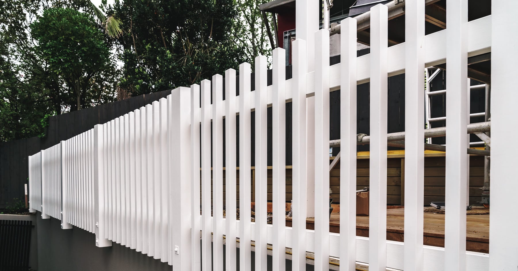 White fence installation progress