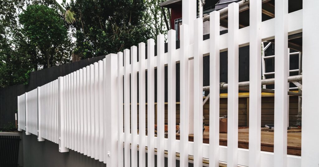 White fence installation progress